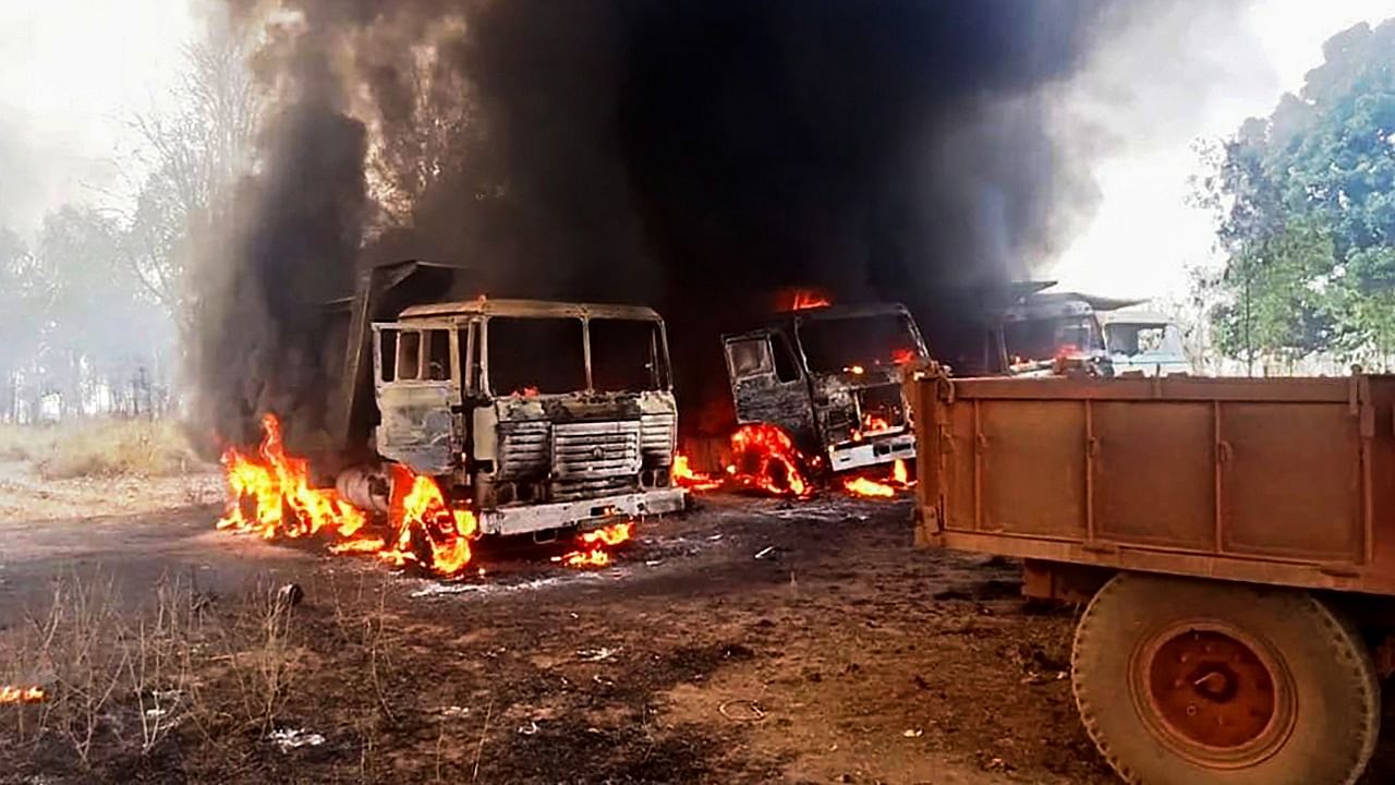 Around 12 vehicles, engaged in road construction work, set ablaze by Naxals, at Dhanora in Kondagaon district, Thursday, March 25, 2021. Credit: PTI Photo