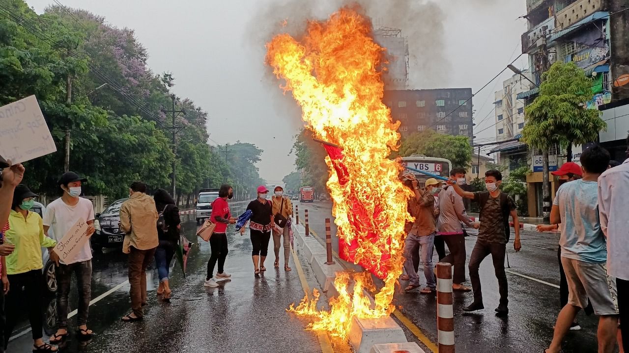 Anti-coup protesters burn a Chinese flag in Yangon, Myanmar April 5, 2021. Credit: Reuters Photo