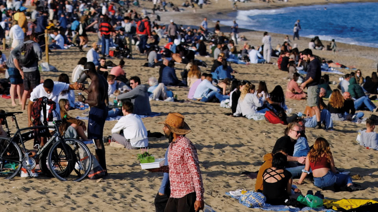 People spend time at Barceloneta beach, amid the coronavirus disease outbreak, in Barcelona, Spain April 2, 2021. Credit: Reuters Photo