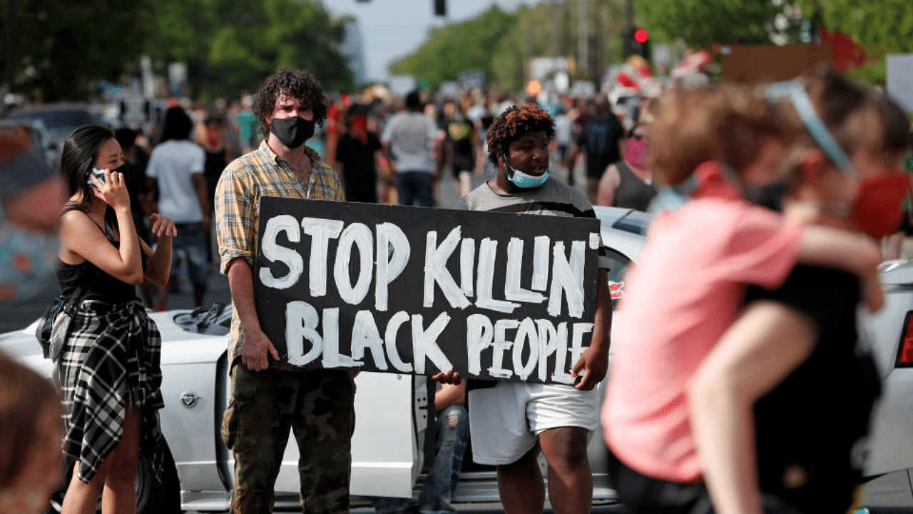 Protesters gather at the scene where George Floyd, an unarmed black man, was pinned down by a police officer kneeling on his neck before later dying in hospital in Minneapolis, Minnesota, U.S. May 26, 2020. Credit: Reuters Photo