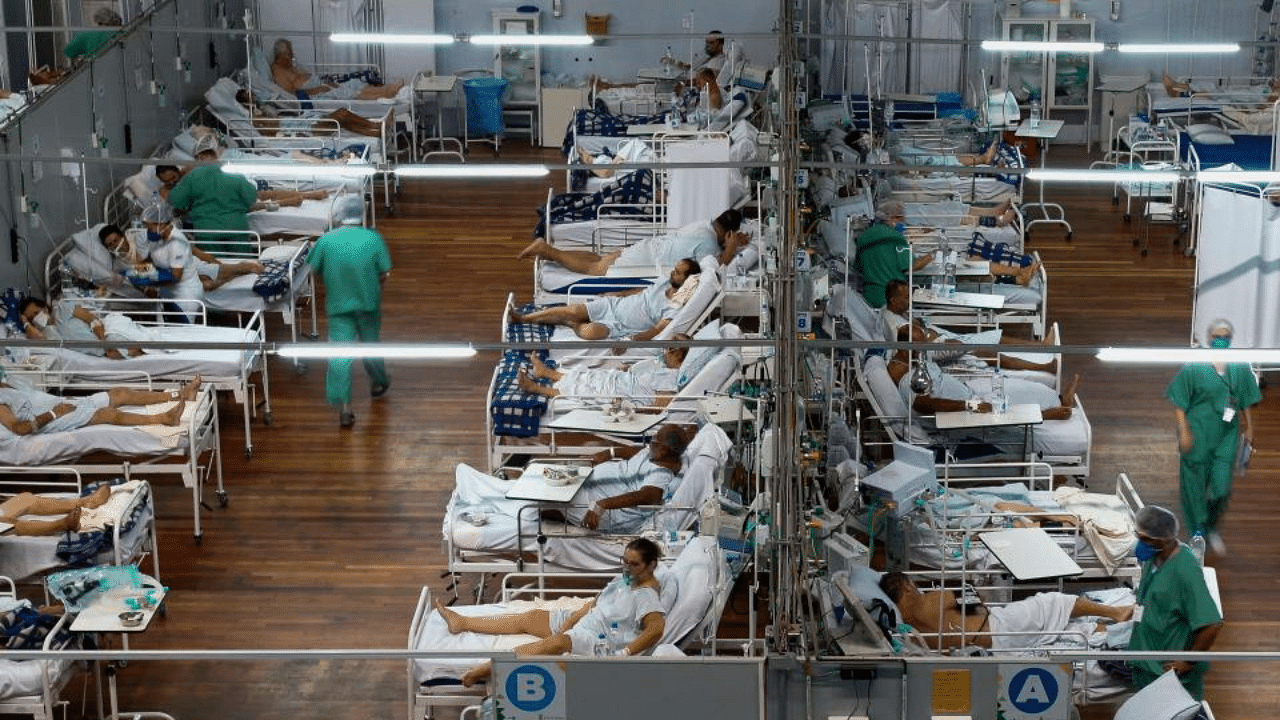 In this file photo taken on March 26, 2021 patients affected by the COVID-19 coronavirus remain at a field hospital set up at a sports gym, in Santo Andre, Sao Paulo state, Brazil.  Credit: AF Photo