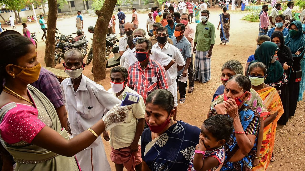People being screened for COVID-19 symptoms as they queue up at a polling station in Tamil Nadu. Credit: PTI Photo