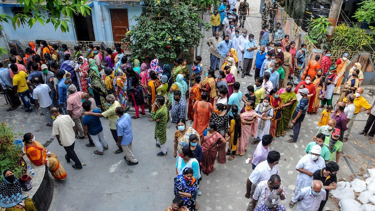 Voters queue up to cast their votes at a polling station during the third phase of West Bengal Assembly elections, at Baruipur in South 24 Parganas district, Tuesday, April 6, 2021. Credit: PTI Photo