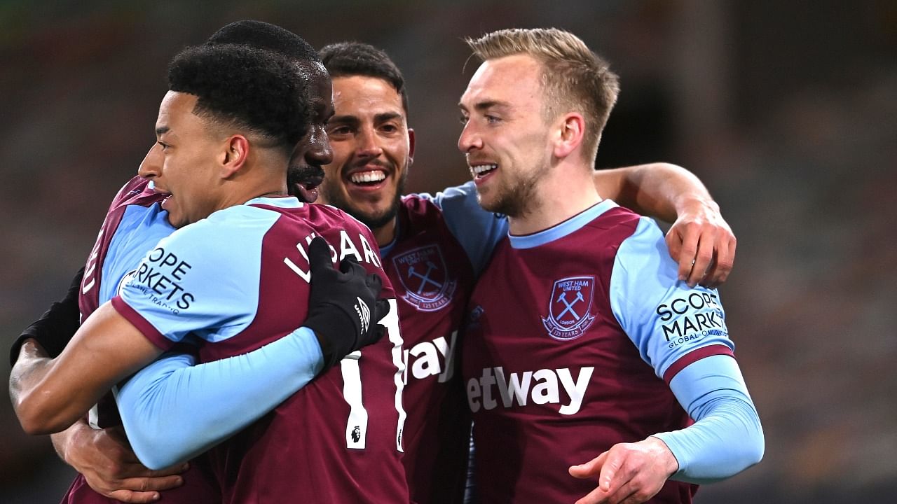 West Ham's Jarrod Bowen, right, celebrates with teammates after scoring his side's third goal during the English Premier League soccer match between Wolverhampton Wanderers and West Ham United at Molineux Stadium in Wolverhampton. Credit: AP/PTI.
