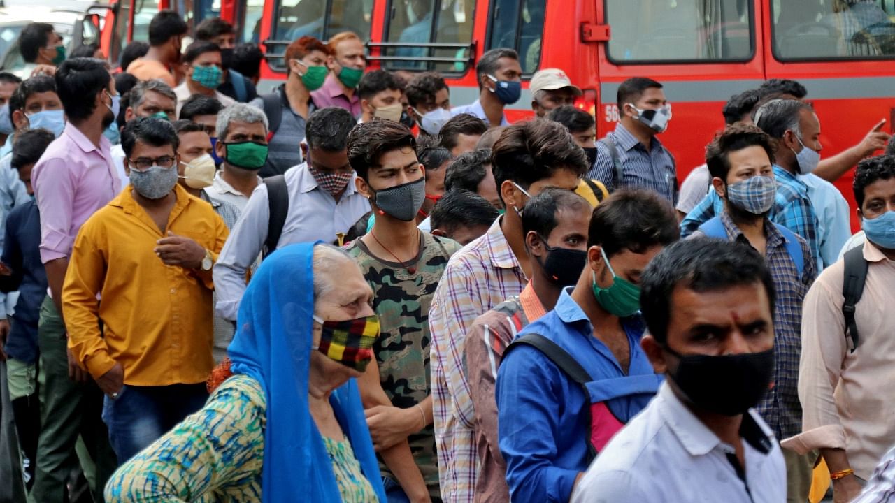 People wait to board passenger buses during rush hour at a bus terminal amidst the spread of the coronavirus disease (Covid-19), in Mumbai, India, April 5, 2021. Credit: Reuters Photo