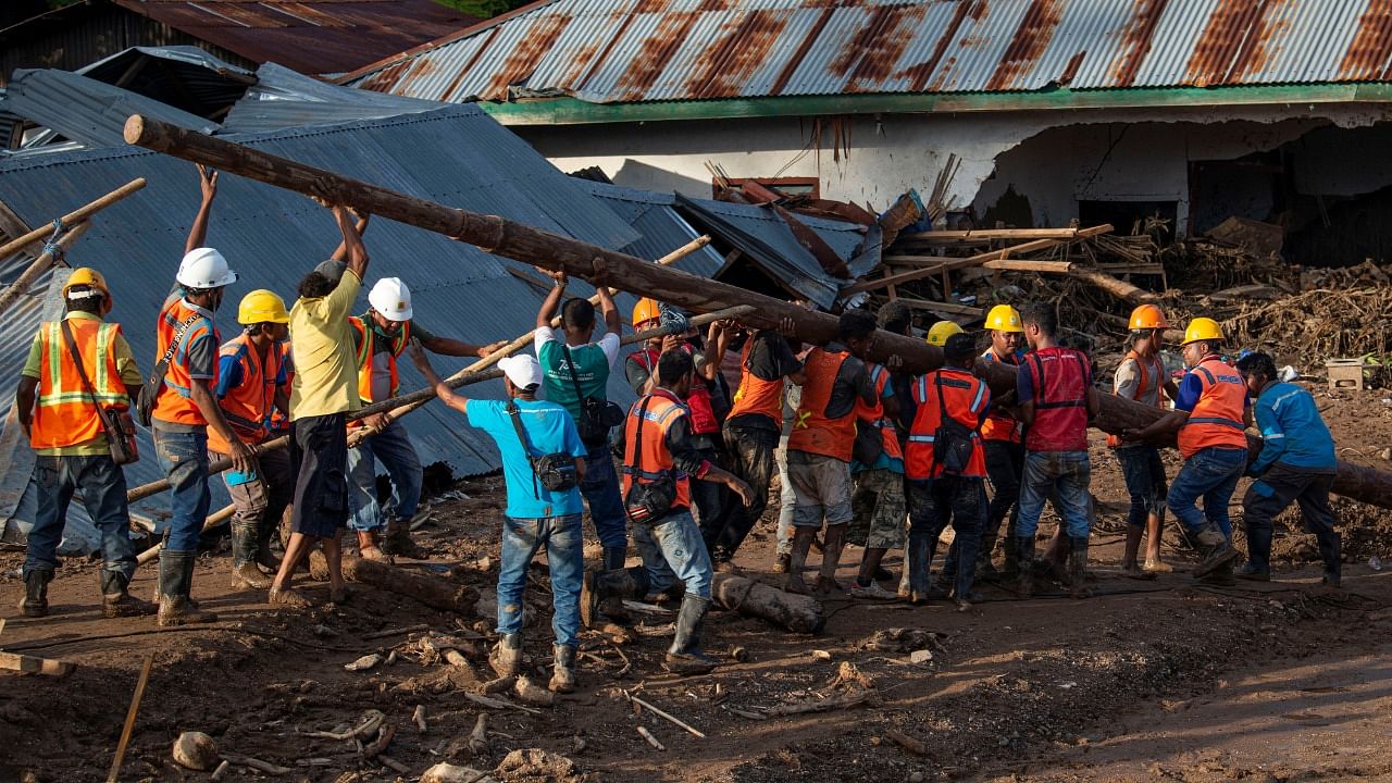 Rescuers have spent the past few days using diggers and shovels to extract mud-covered corpses from the debris. Credit: Reuters Photo