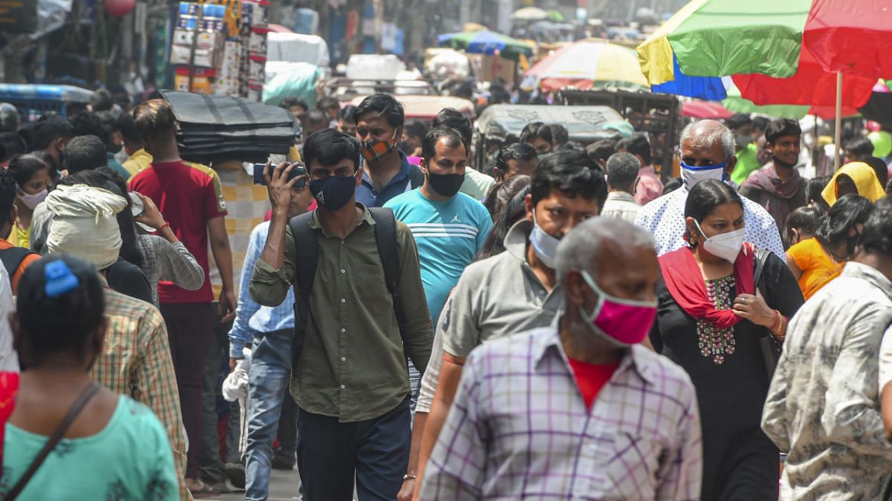 People, not adhering to social distancing norms, at Sadar Bazar, amid coronavirus pandemic, in New Delhi. Credit: PTI photo. 