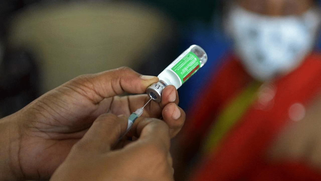 A medical worker prepares to inoculate a woman with the dose of Covishield vaccine against the Covid-19 coronavirus at a government high school in Hyderabad on April 5, 2021.  Credit: AFP Photo