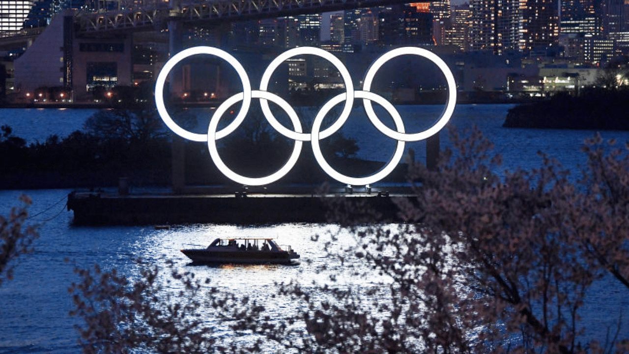 A boat sails past the Tokyo 2020 Olympic Rings on March 25, 2020 in Tokyo, Japan. credit Getty Images