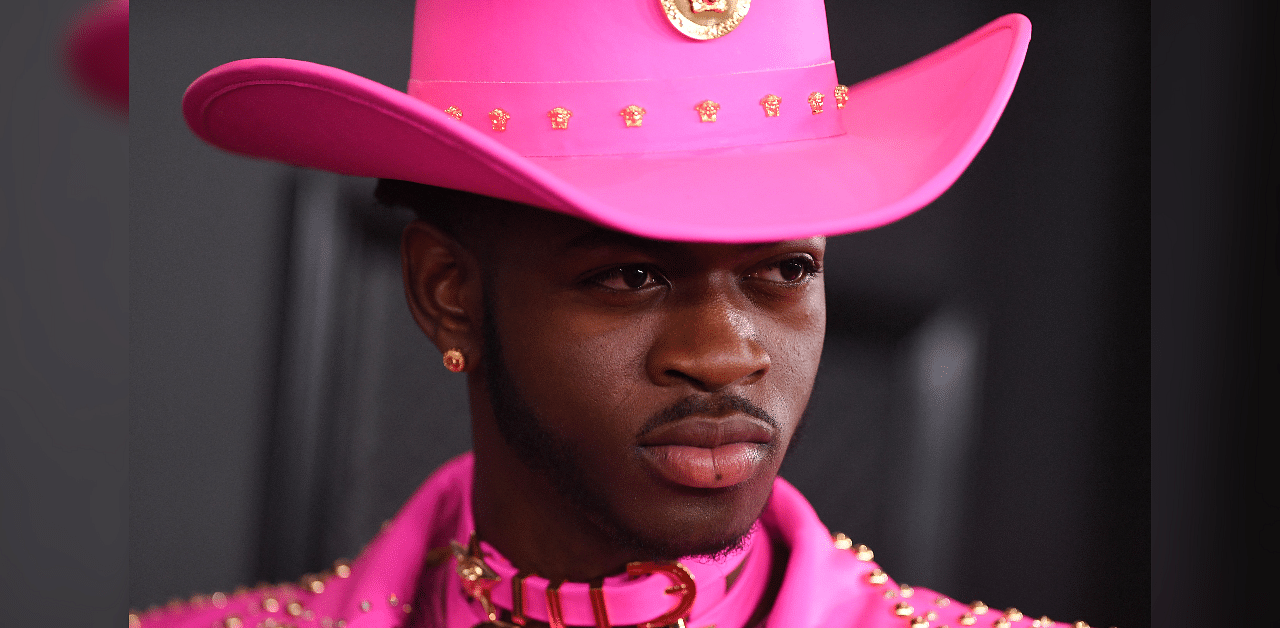 The sale is a follow-up to MSCHF's "Jesus Shoes" -- white Nike Air Max 97s with holy water in the sole. Pictured: Rapper Lil Nas X. Credit: AFP Photo
