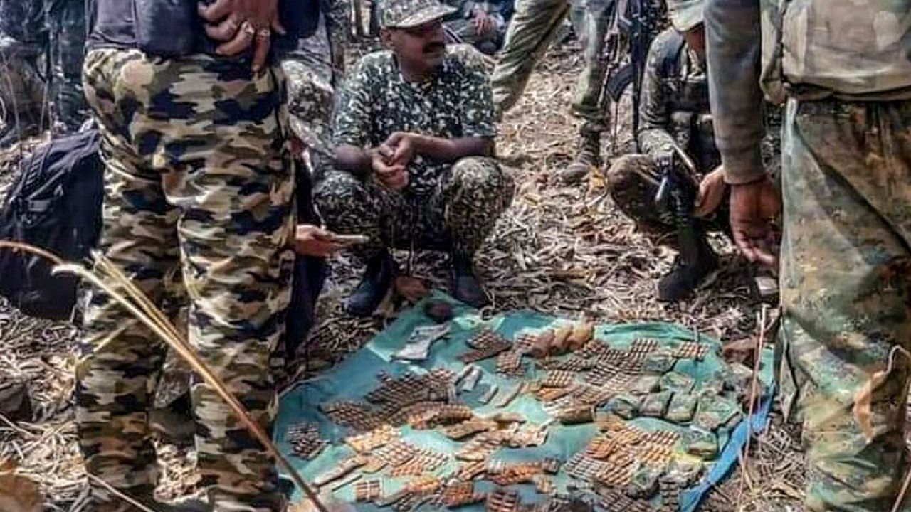Police personnel show cartridges recovered from five Naxals who were killed after an encounter with C60 commandos in Khobra Mendha forest in Gadchiroli district of Maharashtra. Credit: PTI.