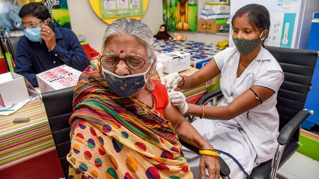 A beneficiary receives the dose of Covid-19 vaccine, at a government dispensary in Patna. Credit: PTI.