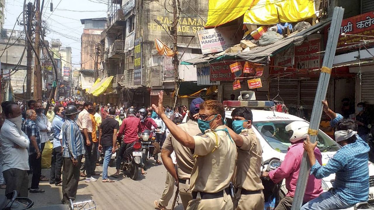 Retail traders stage a protest against Covid-19 restrictions imposed till April 30 by the Maharashtra Government, at a market in Nagpur, Tuesday, April 6, 2021. Credit: PTI Photo