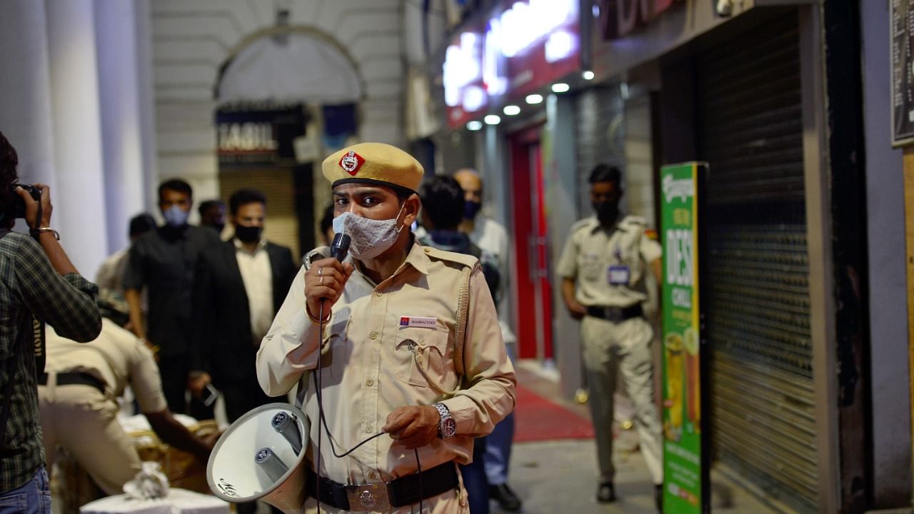 Security personnel during night curfew, imposed by Delhi government to curb Covid-19 spread, at Connaught Place in New Delhi, Tuesday, April 6, 2021. Credit: PTI Photo