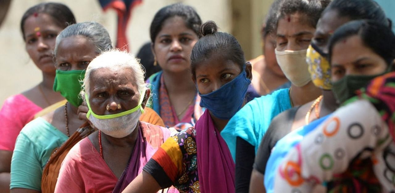 Voters stand in a line to cast their vote outside a polling station during Tamil Nadu state legislative election in Chennai on 6, 2021. Credit: AFP Photo