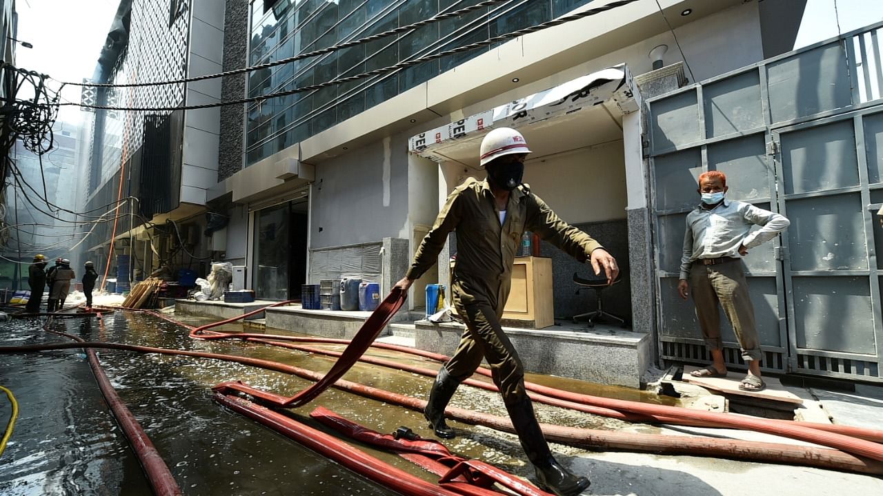 Firefighters attempt to douse a fire that broke out in a factory at Dilshad Garden. Credit: PTI Photo