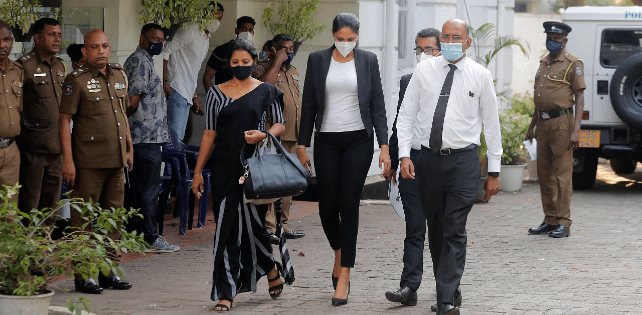 Mrs. World 2019 Caroline Jurie, center, leaves a police station after obtaining bail in Colombo. Credit: AP Photo