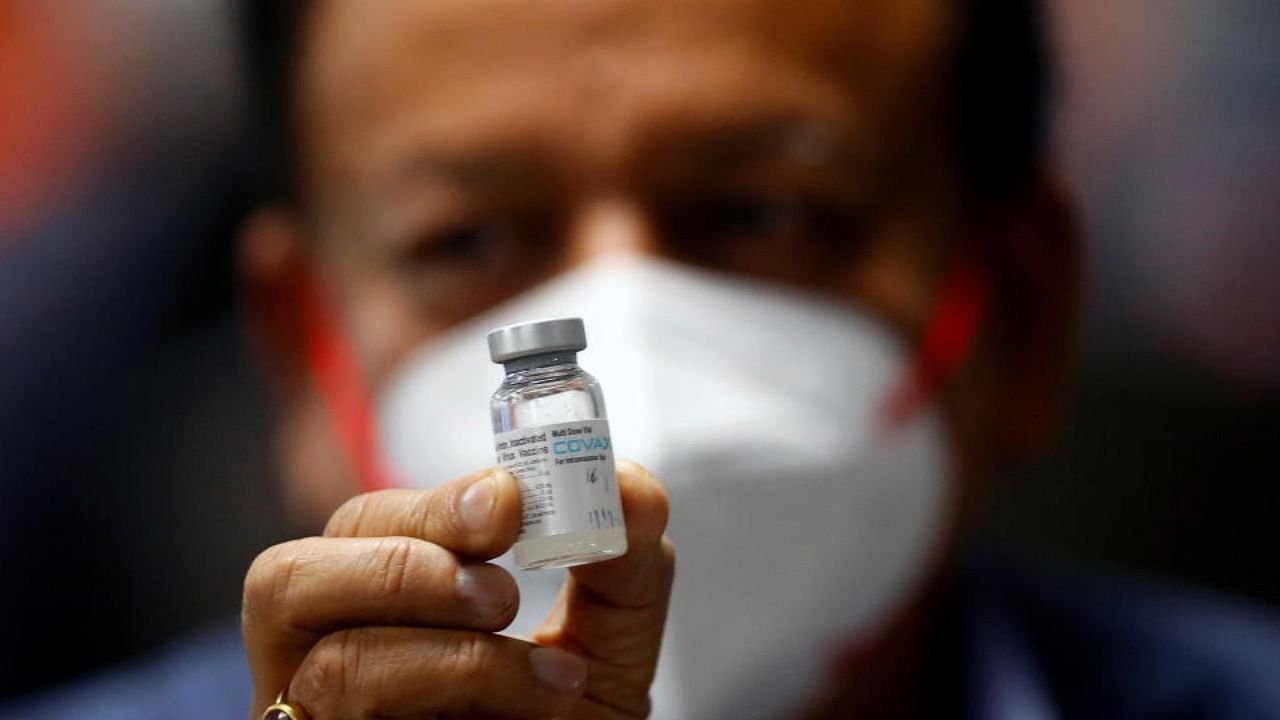 Indian Health Minister Harsh Vardhan holds a dose of Bharat Biotech's COVID-19 vaccine called COVAXIN. Credit: Reuters Photo