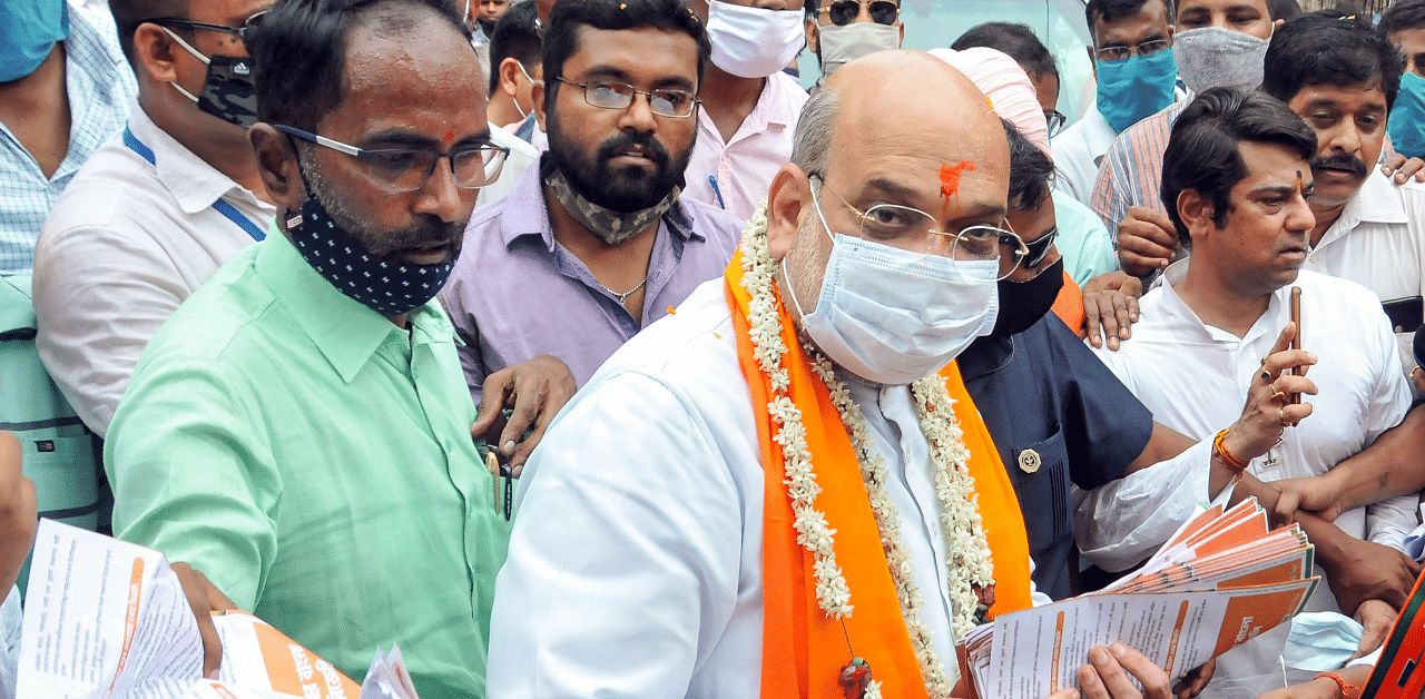 Holding flags of the party and saffron and green balloons, participants of the roadshow chanted slogans such as 'Jai Shri Ram' and 'Amit Shah Zindabad'. Credit: PTI Photo