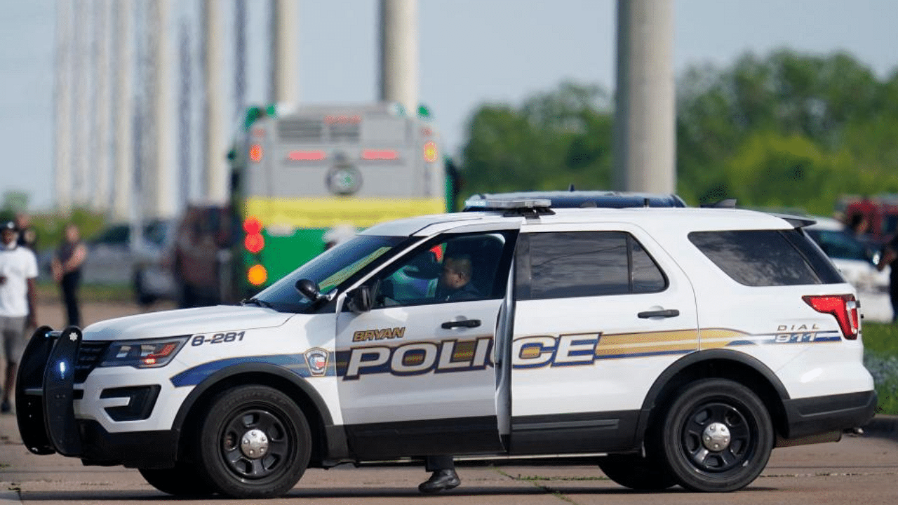 A Bryan police officer blocks road access near the scene of a mass shooting at an industrial park in Bryan in Bryan, Texas on April 8, 2021. Credit: AFP Photo