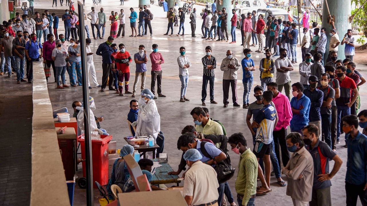 People queue up to give samples for Covid-19 test via RT-PCR, at Turbhe Railway Station in Navi Mumbai, Thursday, April 8, 2021. Credit: PTI Photo