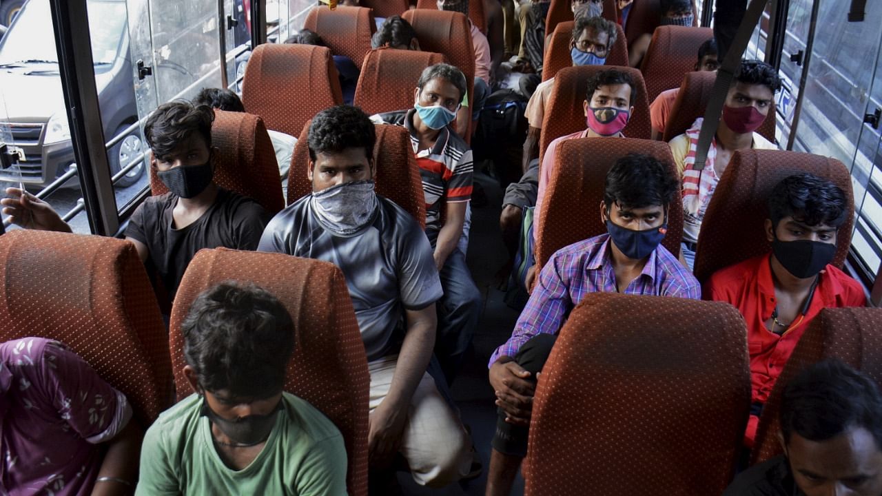 Migrant workers travel in a bus to leave for their home states, amid surge in Covid-19 cases, in Thane, Thursday, April 8, 2021. Credit: PTI Photo