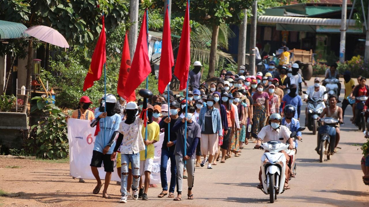 Protesters hold flags as they march in a demonstration against the military coup in Launglone township in Myanmar's Dawei district. Credit: AFP Photo/Dawei