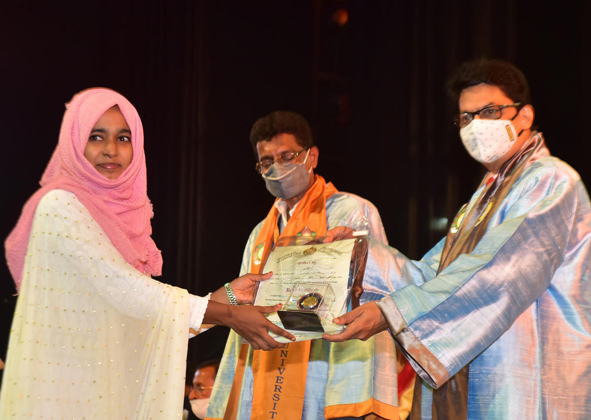 A student receives the rank certificate and medal from Mangalore University Vice-Chancellor Prof P S Yadapadithaya, during the 39th annual convocation, at the university campus, in Mangalagangothri, on Saturday.