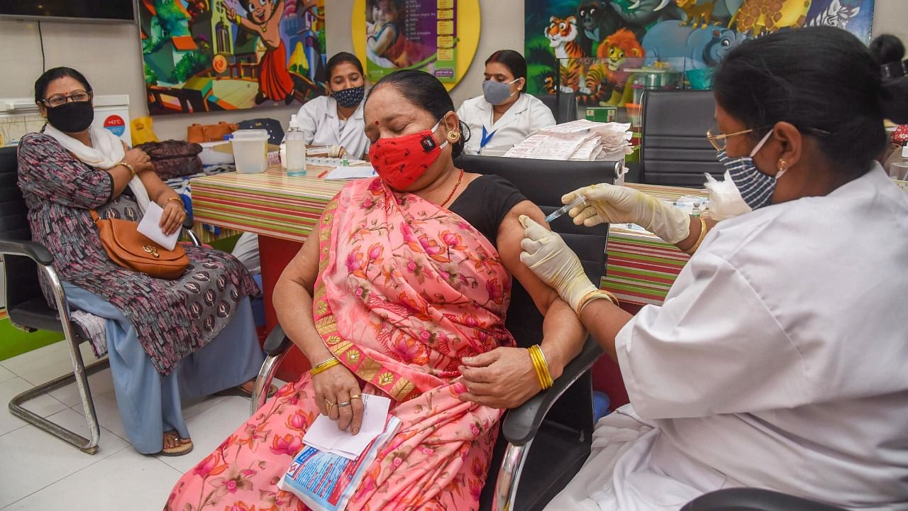 A woman receives the Covid-19 vaccine at a government dispensary in Patna. Credit: PTI Photo