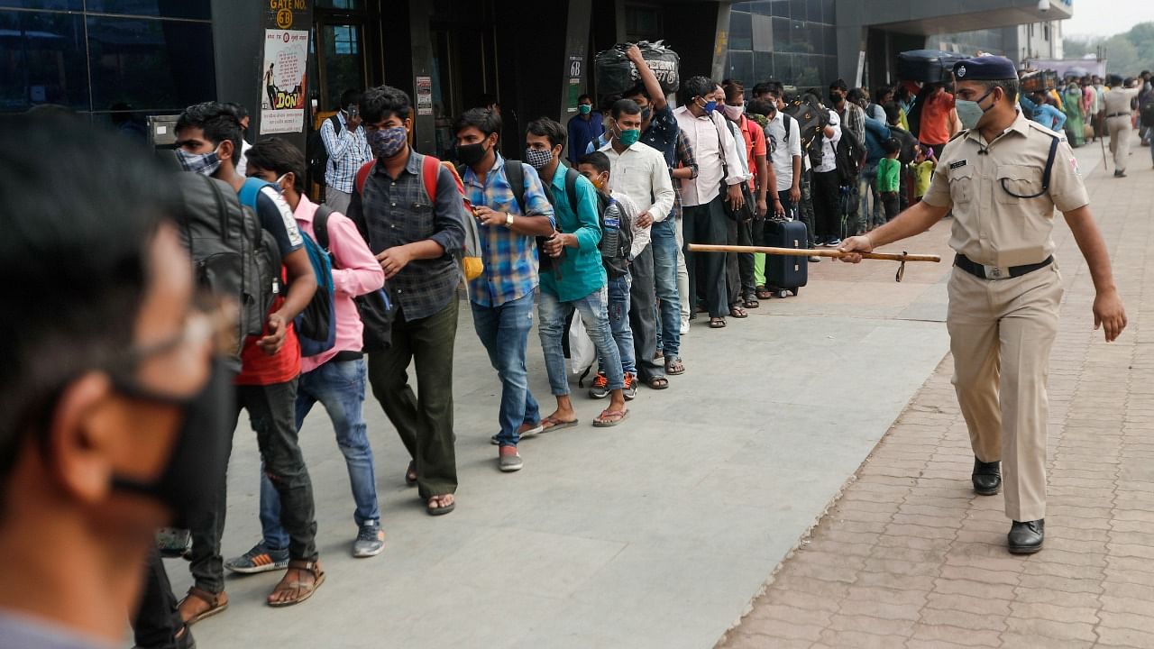 A police officer points at people in line at a railway station amidst the spread of the coronavirus disease (Covid-19) in Mumbai, India, April 11, 2021. Credit: Reuters Photo