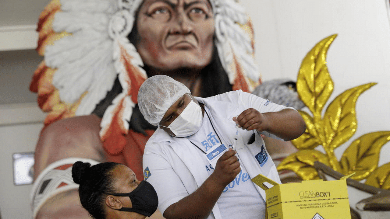 A healthcare worker prepares a dose of Sinovac's CoronaVac coronavirus disease (COVID-19) vaccine at Cacique de Ramos, one of the most traditional carnival blocks of Rio de Janeiro, Brazil. Credit: Reuters photo. 