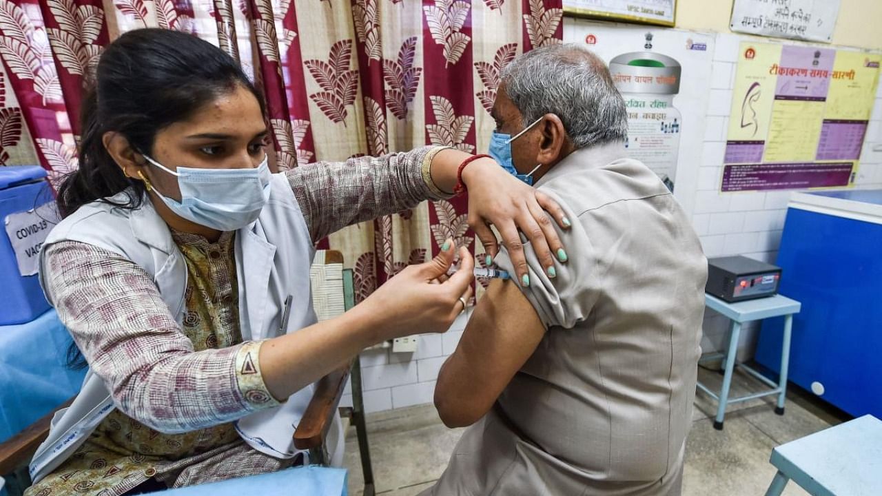 A medic administer a Covid-19 vaccine to a beneficiary during the vaccination festival 'Tika Utsav' at SDMC Urban Public Health Centre Daryaganj , in New Delhi. Credit: PTI Photo