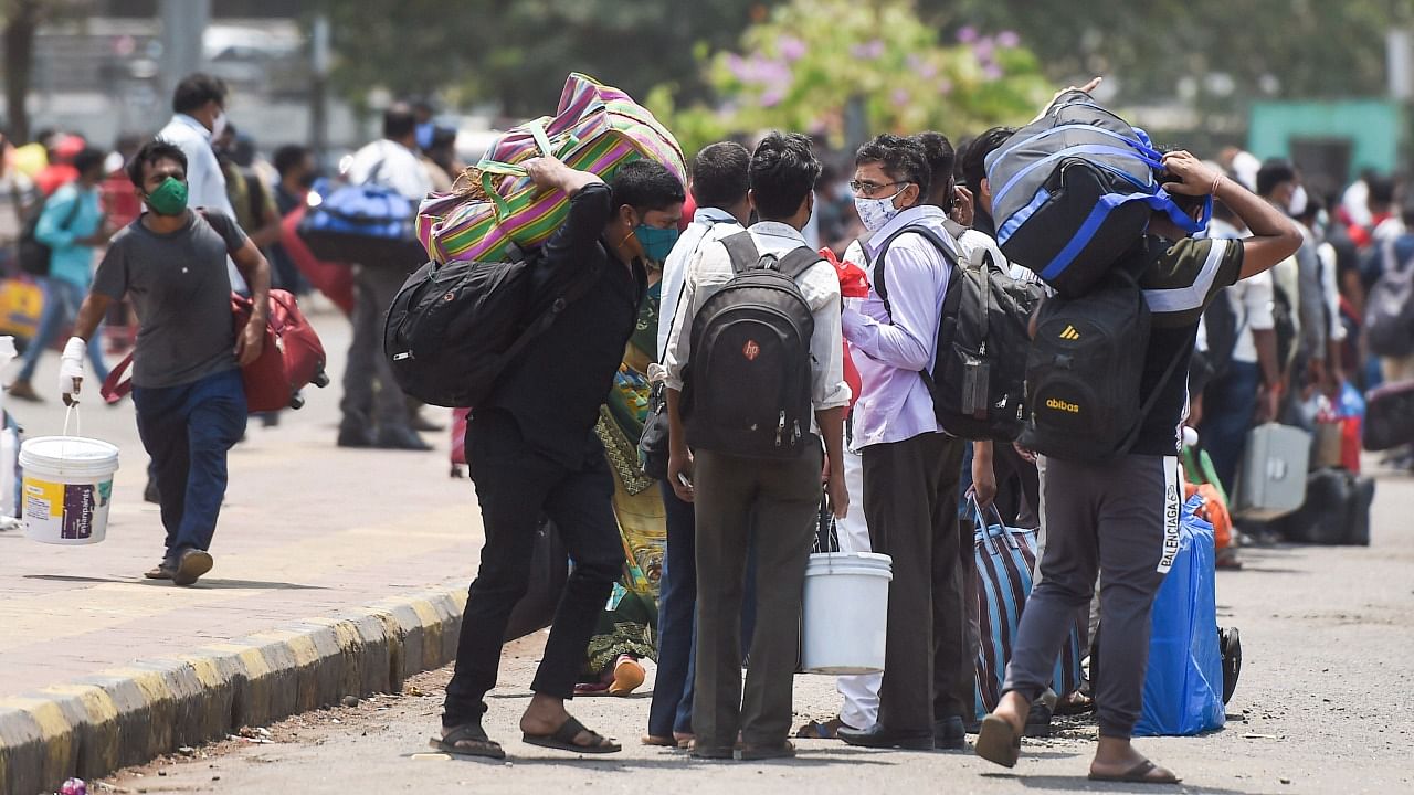 Passengers arrive at the Lokmanya Tilak Terminus to board outstation trains, amid spike in Covid-19 cases, during weekend lockdown in Mumbai, Saturday, April 10, 2021. Credit: PTI Photo