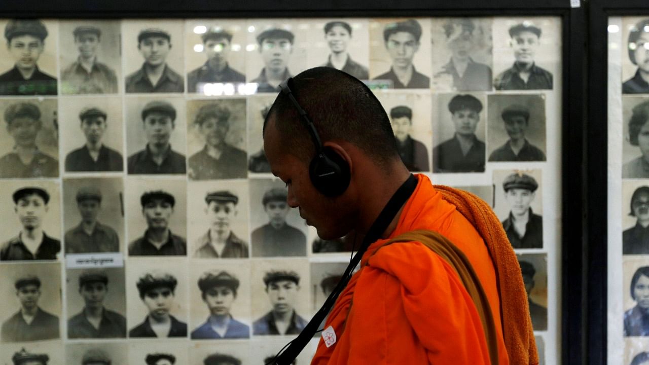 A Buddhist monk looks at pictures of victims of the Khmer Rouge regime at Tuol Sleng Genocide Museum in Phnom Penh, Cambodia June 1, 2016. Credit: Reuters File Photo