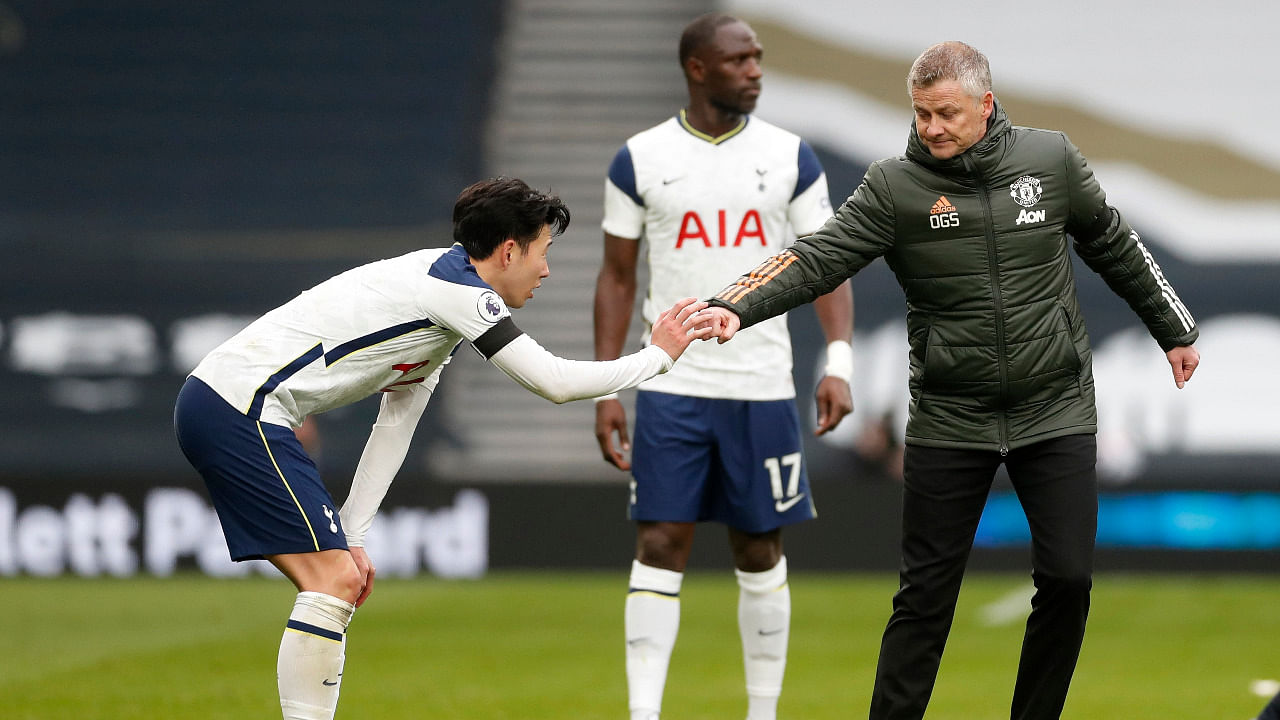 Manchester United manager Ole Gunnar Solskjaer bumps fists with Tottenham Hotspur's Son Heung-min after the match. Credit: Reuters Photo