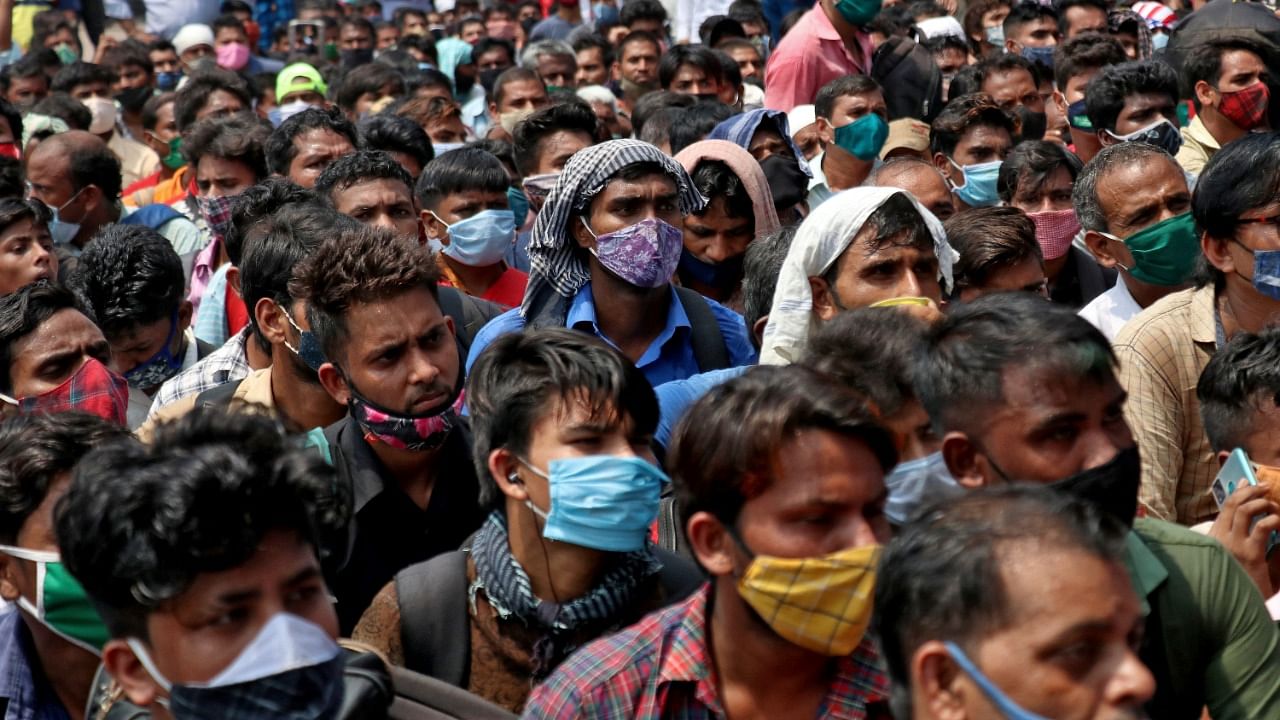 People wearing protective face masks wait to enter the Lokmanya Tilak Terminus railway station, amid the spread of the coronavirus disease (Covid-19) in Mumbai, India, April 12, 2021. Credit: Reuters Photo