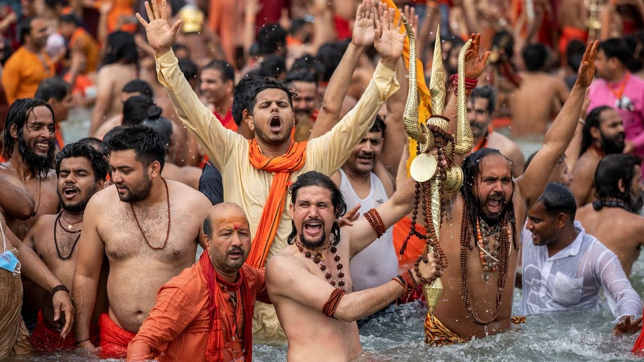 Sadhus, take a dip in the Ganges river during Shahi Snan at Kumbh Mela, amid rising Covid-19 cases. Credit: Reuters Photo