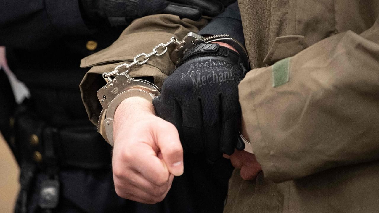 Handcuffed defendant Abdullah A (C), accused of stabbing a German tourist to death in Dresden. Credit: AFP Photo