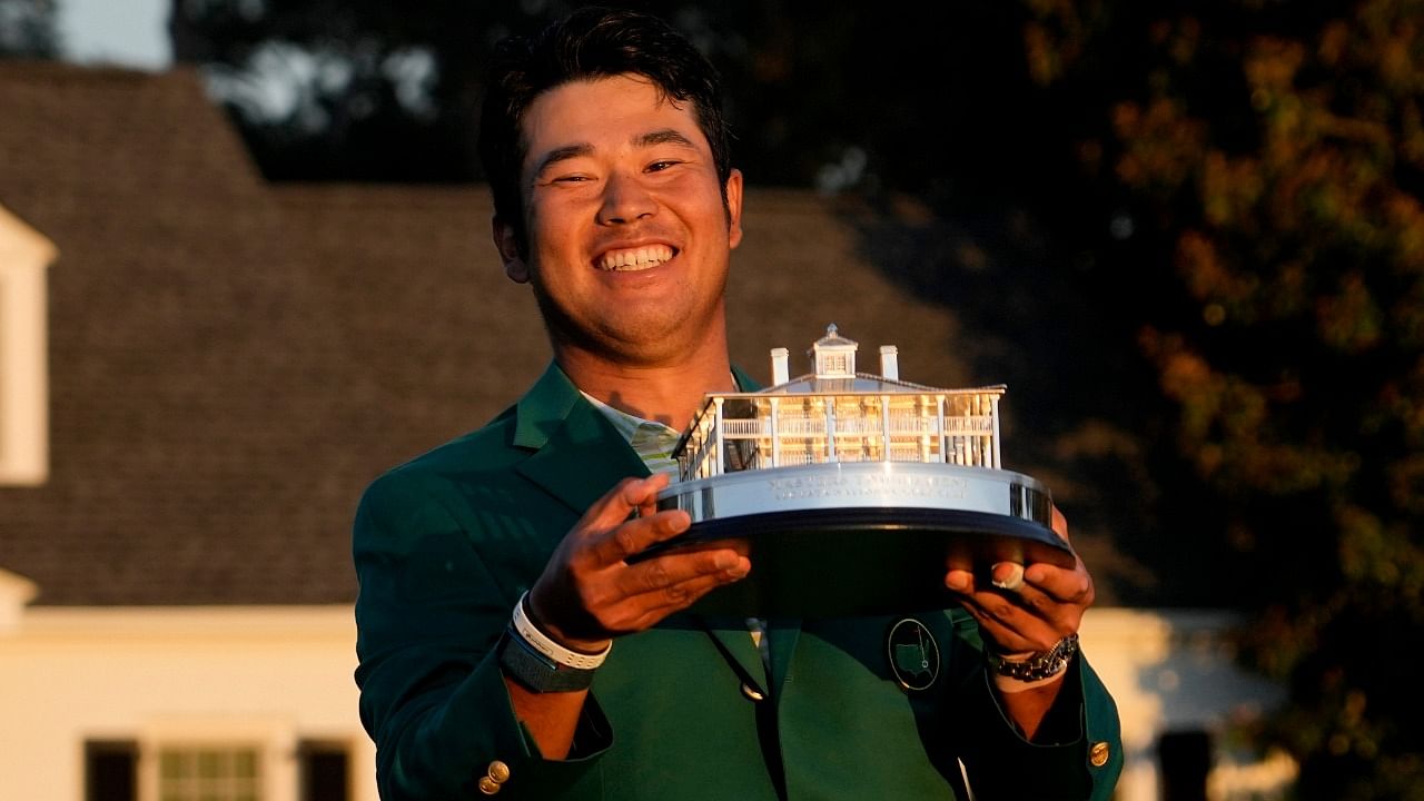 Hideki Matsuyama, of Japan, holds the trophy after winning the Masters golf tournament. Credit: AP Photo