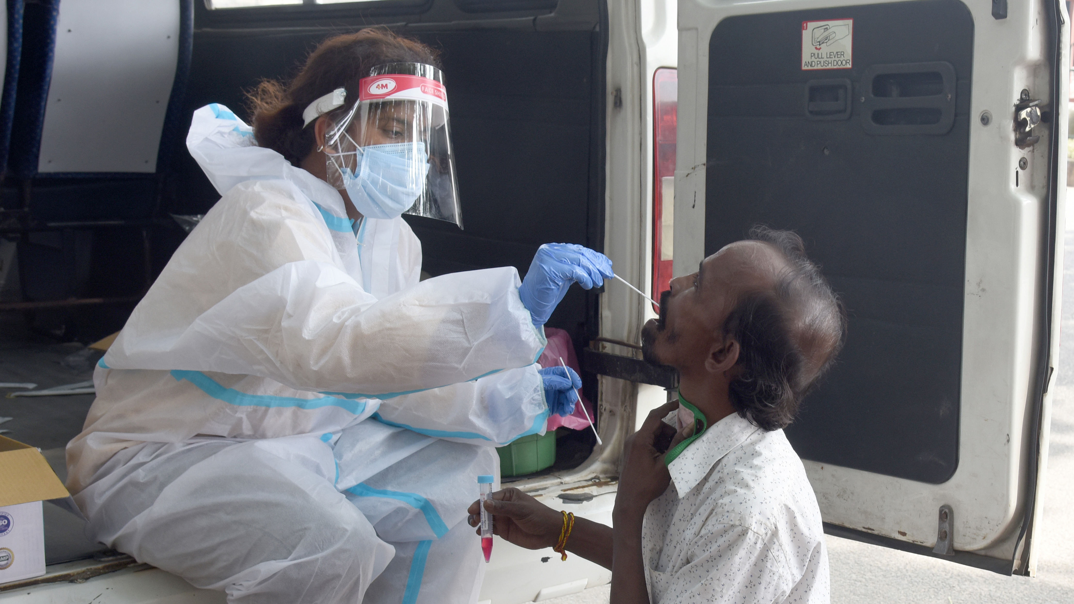 A health worker collects nasal swabs at a check-up camp in Bengaluru. Credit: DH Photo/ SK Dinesh