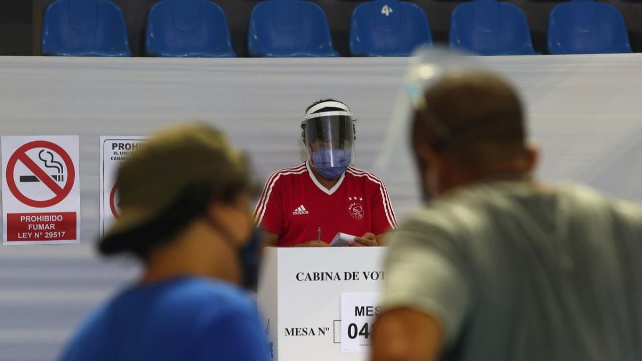 People wearing face masks and face shields due to the ongoing coronavirus disease (COVID-19) vote during the presidential and parliamentary elections, at a polling station in Lima. Credit: Reuters Photo
