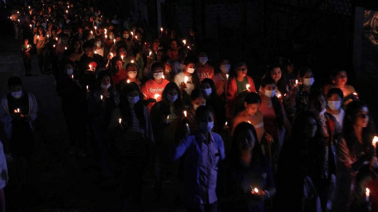 This photo taken and received from an anonymous source via Facebook on April 11, 2021 shows protesters marching during a candle-lit protest against the military coup in Mogok in Myanmar's Mandalay division. Credit: AFP 