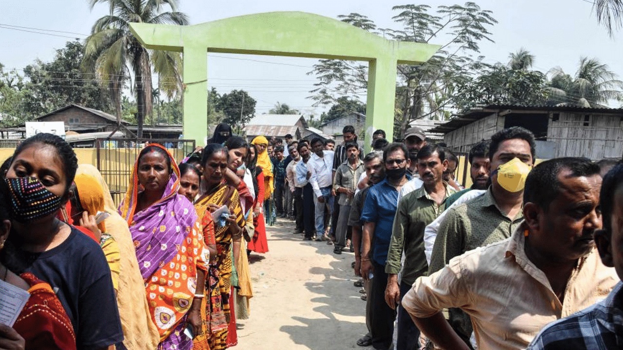 Voters wait in queue to cast their ballots during Phase 1 of Assam's legislative election in Koliabor, some 186 km from Guwahati on March 27, 2021. Credit: AFP Photo