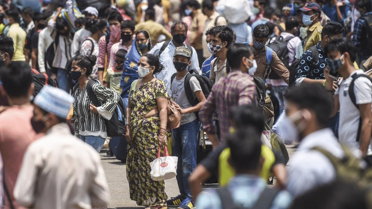 Passengers arrive at the Lokmanya Tilak Terminus to board outstation trains, amid spike in COVID-19 cases, during weekend lockdown in Mumbai, Saturday, April 10, 2021. Credit PTI Photo