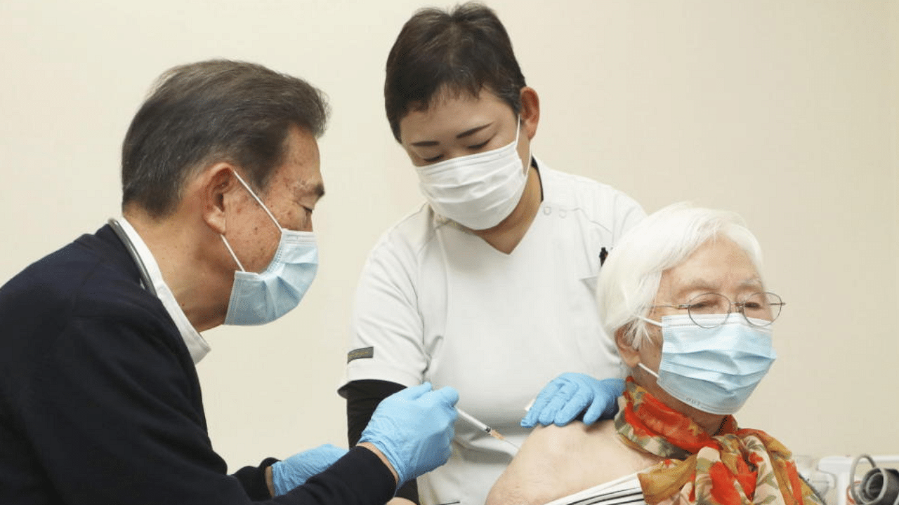 An elderly woman receives a coronavirus vaccine shots at a nursery home in Tsu in Mie Prefecture, central Japan, April 12, 2021, in this photo released by Kyodo. Kyodo. Credit: Reuters