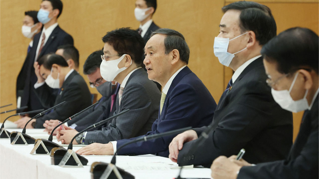 Japan's Prime Minister Yoshihide Suga (C) speaks at a cabinet meeting at the prime minister's office in Tokyo. Credit: AFP Photo