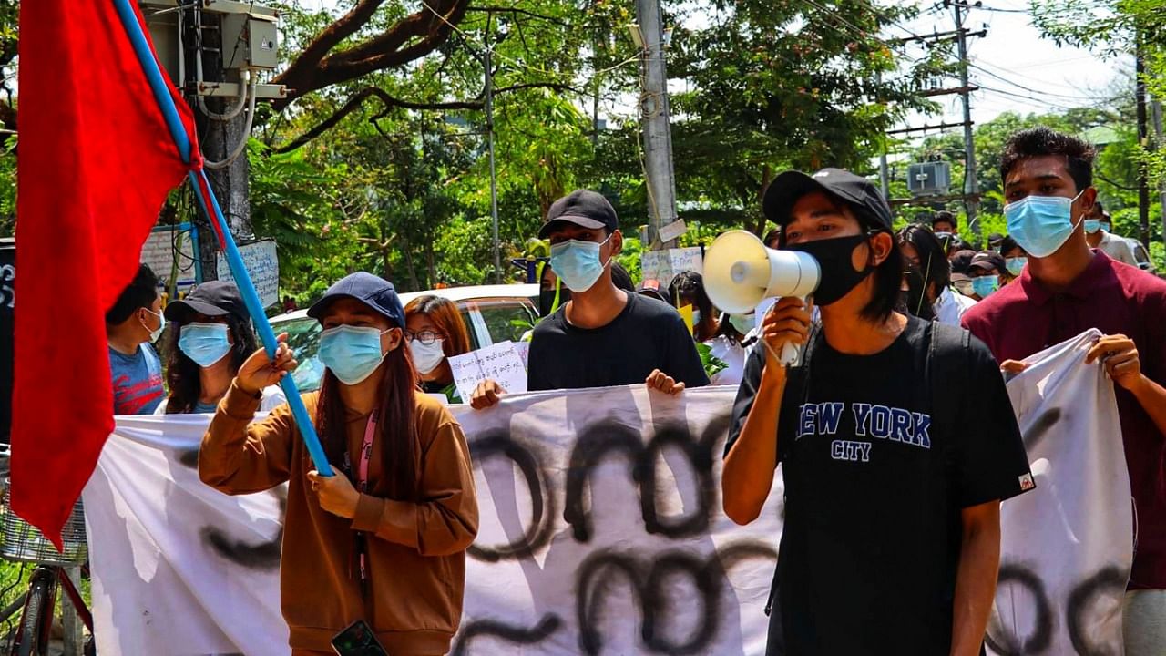 This photo taken and received courtesy of an anonymous source via Facebook on April 13, 2021 shows protesters taking part in a demonstration against the military coup in Yangon's Thuwana township. Credit: AFP Photo