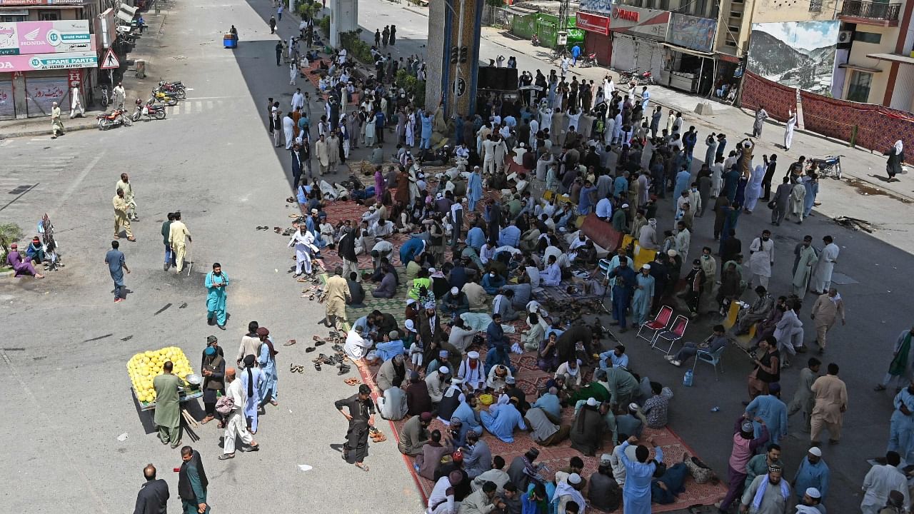 Supporters of Tehreek-e-Labbaik Pakistan (TLP) gather on a blocked street near commercial areas to protest the arrest of their leader as he was demanding the expulsion of the French ambassador over depictions of Prophet Muhammad, in Rawalpindi. Credit: AFP Photo
