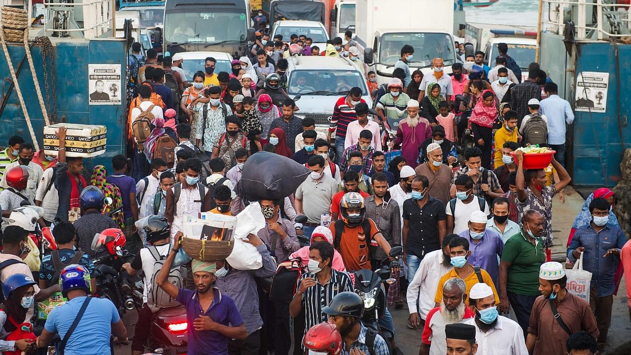 People get off from a ferry as authorities ordered eight-day lockdown to contain the spread of the Covid-19 coronavirus, in Munshigamj district, about 70 km from Dhaka. Credit: AFP Photo