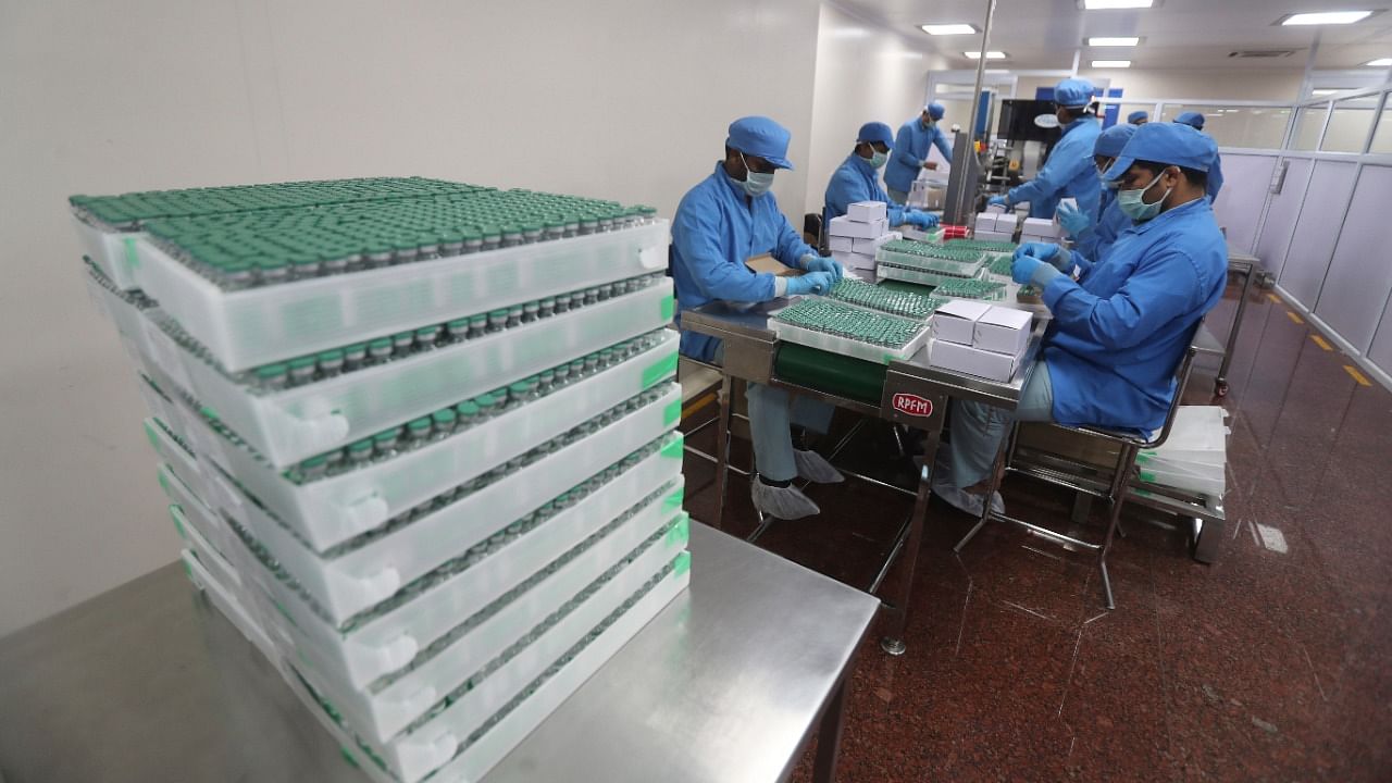 Employees pack boxes containing vials of AstraZeneca's Covishield vaccine at the Serum Institute of India, in Pune. Credit: AP/PTI File Photo
